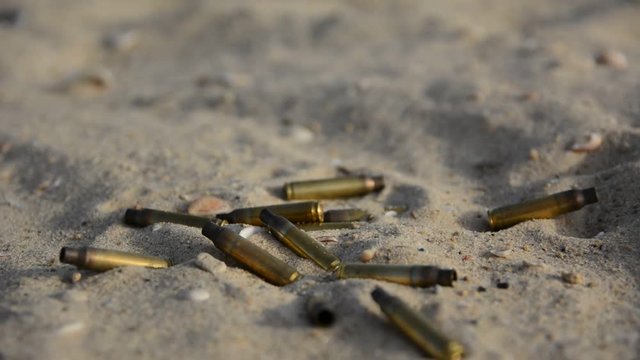signs of war. Empty bullet cases on the sand