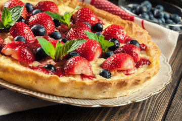 Tart with curd cheese, strawberries and blueberries