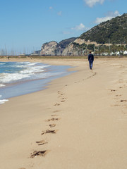 Person walking on the beach of Castelldefels