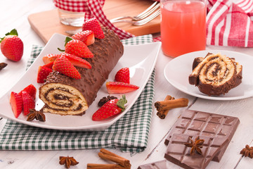 Chocolate roll with strawberries.