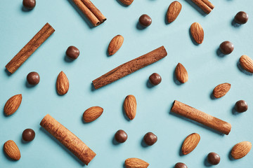 Almond, cinnamon chocolate balls on a blue paper background, beautiful pattern. Flat lay