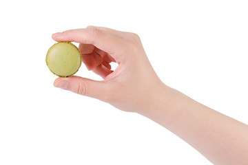 young female hand holding green macaron isolated on white