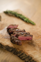 sliced medium filet mignon on wood board