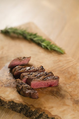 sliced medium filet mignon on wood board