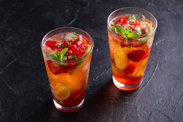Strawberry mojito cocktail with berries, lime, mint and ice. Summer berry cocktail
