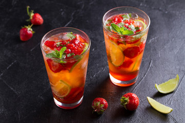Strawberry mojito cocktail with berries, lime, mint and ice. Summer berry cocktail