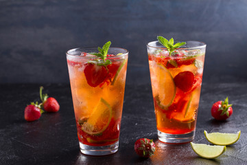 Strawberry mojito cocktail with berries, lime, mint and ice. Summer berry cocktail