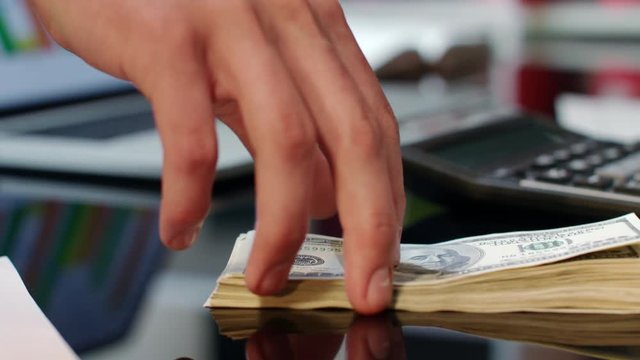 Hand giving dollar bills on office table. Bank offers instant money transfer. Simple financial transactions. Transfer money cash from hand to hand. New credit proposition. Business money deal