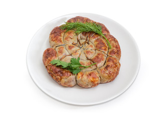 Baked homemade sausage curtailed by spiral with greens