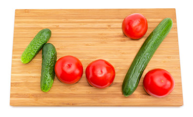 Number 100 and percent sign laid out with cucumbers, tomatoes
