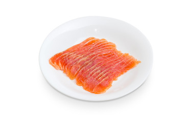 Sliced fillet of salted salmon on a white dish
