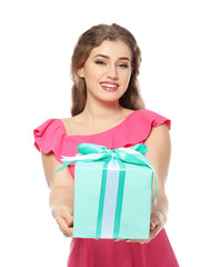 Beautiful young woman with gift box on white background