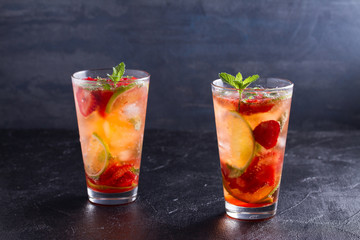 Strawberry mojito cocktail with berries, lime, mint and ice. Summer berry cocktail