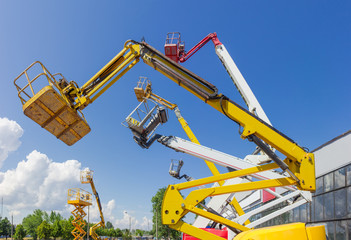 Booms and top parts of different articulated boom lifts