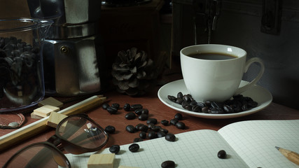 Coffee cup and coffee beans on wooden vintage image background..