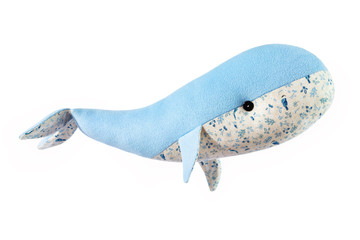 Closeup image of blue toy whale pillow with ornament isolated at white background.
