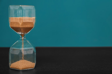 Hourglass on color background. Time management concept