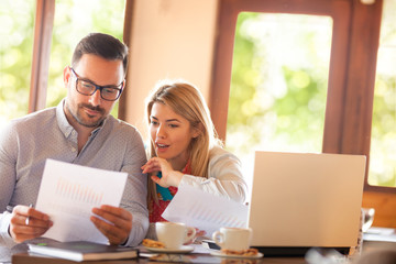 couple working together sitting at the cafe during the coffee break