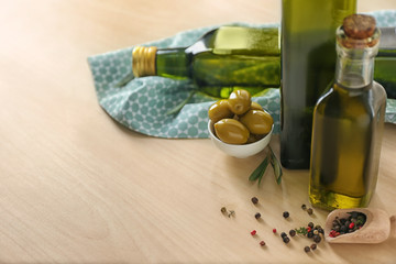 Composition with bottles of olive oil on table