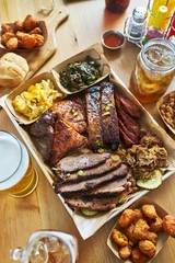  texas style bbq tray with smoked brisket, st louis ribs, pulled pork, chicken, hot links, and sides © Joshua Resnick