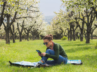 Young woman using her tablet outdoors