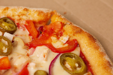 Pizza in cardboard delivery box.