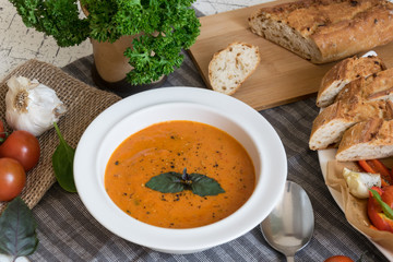 Roasted pepper soup and roasted tomatoes with fresh basil and home-made onion baguette