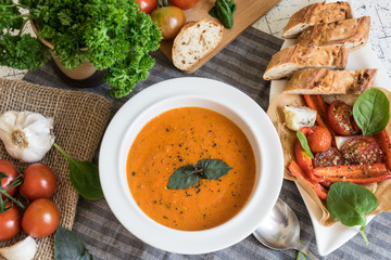 Roasted pepper soup and roasted tomatoes with fresh basil and home-made onion baguette