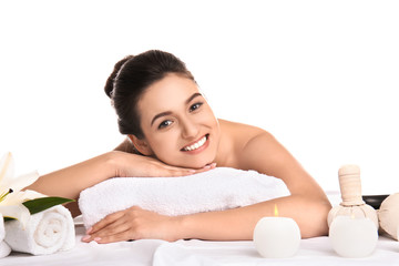 Young woman relaxing on massage table against white background. Spa procedures