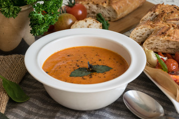 Roasted pepper soup and roasted tomatoes with fresh basil and home-made onion baguette