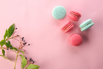 Flat lay composition with tasty macarons on color background