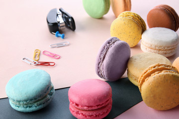 Delicious macarons on color background