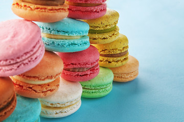 Delicious macarons on color background