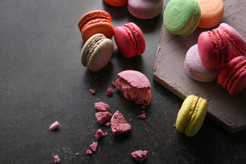 Colorful macarons on dark background