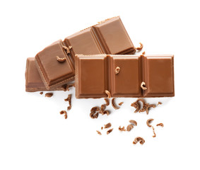 Pieces of milk chocolate on white background