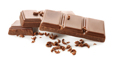Pieces of milk chocolate on white background