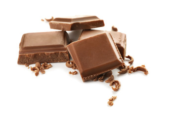 Pieces of milk chocolate on white background