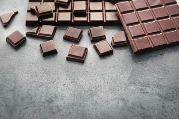 Tasty dark chocolate on grey background