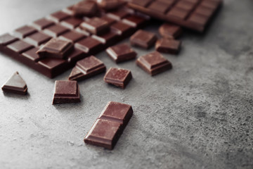 Tasty dark chocolate on grey background