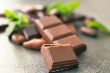 Pieces tasty chocolate on table, closeup