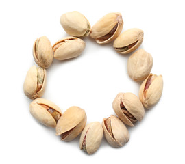 Frame made of tasty pistachio nuts on white background