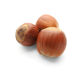 Tasty hazelnuts on white background