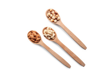 Spoons with different nuts on white background