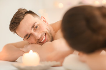 Fototapeta na wymiar Young couple relaxing in spa salon