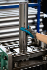 Metallurgy heavy industry. Factory for production of heavy pellet stoves and boilers. Worker hands close up. Extremely dark conditions and visible noise.