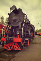 Old black steam locomotive with red wheels