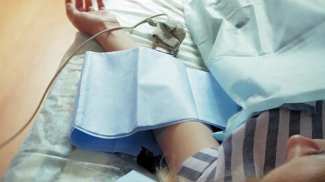 A woman in a hospital undergoing UV blood irradiation therapy