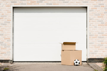 Front view of boxes, soccer ball in front of garage gate
