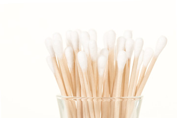 Swabs standing in a glass on a white background