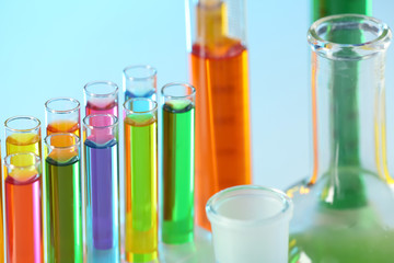 Test tubes with colorful liquids in rack, closeup